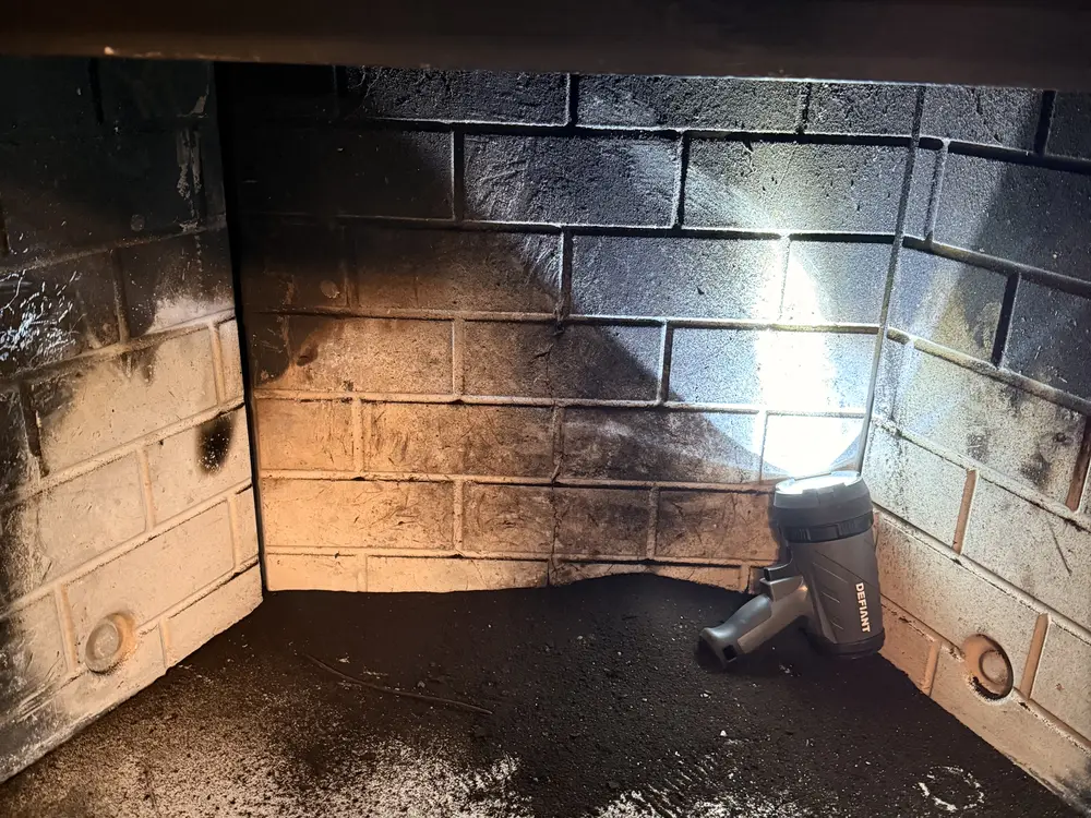 Firebox panels under a work light during an inspection